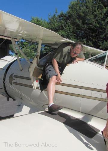 Climbing Into Biplane Cockpit